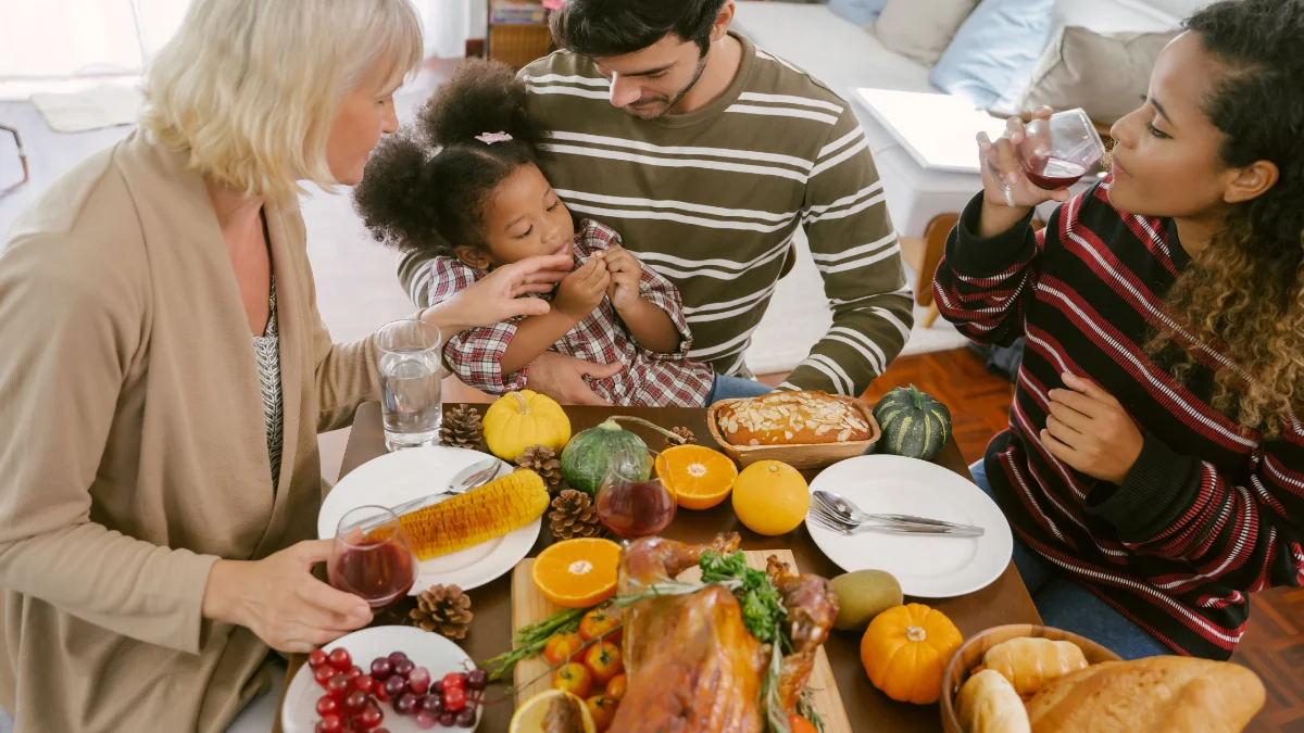 A family gathered around a Thanksgiving table together